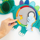 Jolly Designs. Dinozaur. Podróżna książeczka sensoryczno-manipulacyjna