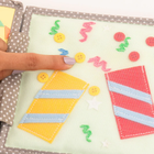 Jolly Designs. Sto lat! Książeczka sensoryczno-manipulacyjna