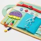 Jolly Designs. Kosmos. Tablica manipulacyjna. Książeczka sensoryczna