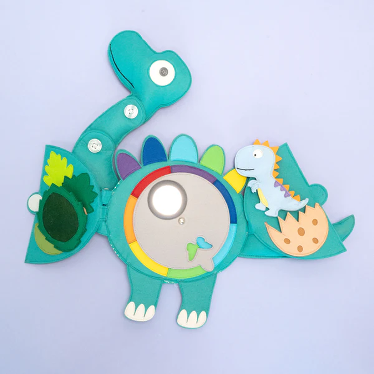 Jolly Designs. Dinozaur. Podróżna książeczka sensoryczno-manipulacyjna