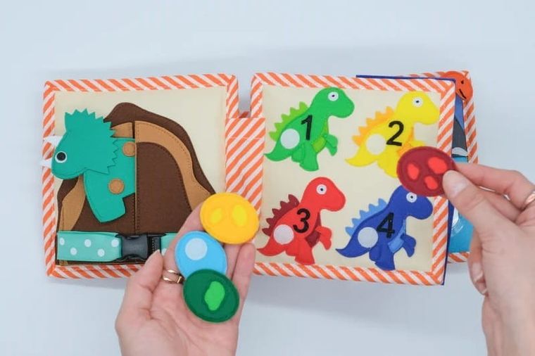 Jolly Designs. Dino. Książeczka sensoryczno-manipulacyjna